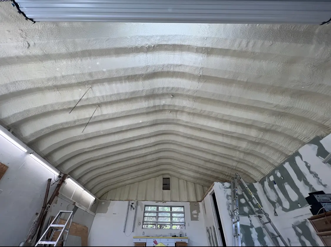 Spray polyurethane foam applied to the underside of a metal roof deck in Enid